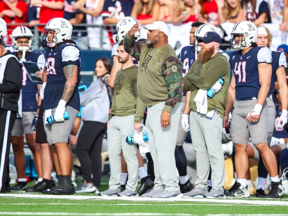 Arizona Football defensive line coach Ricky Hunley communicates with players on the field during the Nov. 18 football game against Utah.