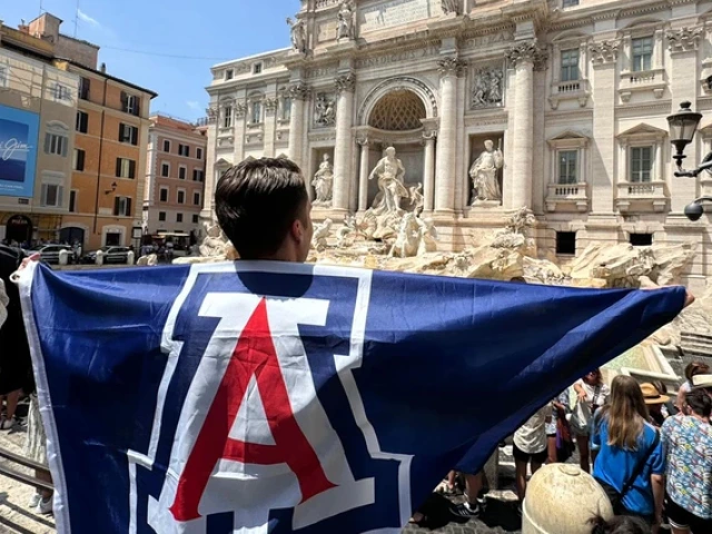 University of Arizona student holds flag with Block A