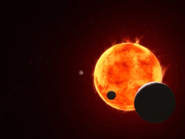 Artist's illustration of the TRAPPIST system shows the star as an orange glowing ball with four of its seven planets orbiting around it. 