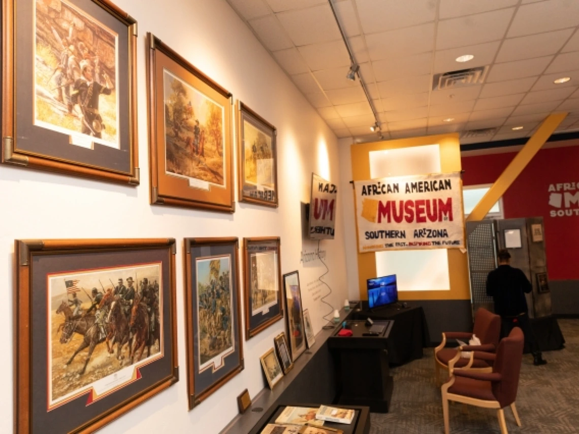 several paintings hanging on the wall at the african american museum of southern arizona